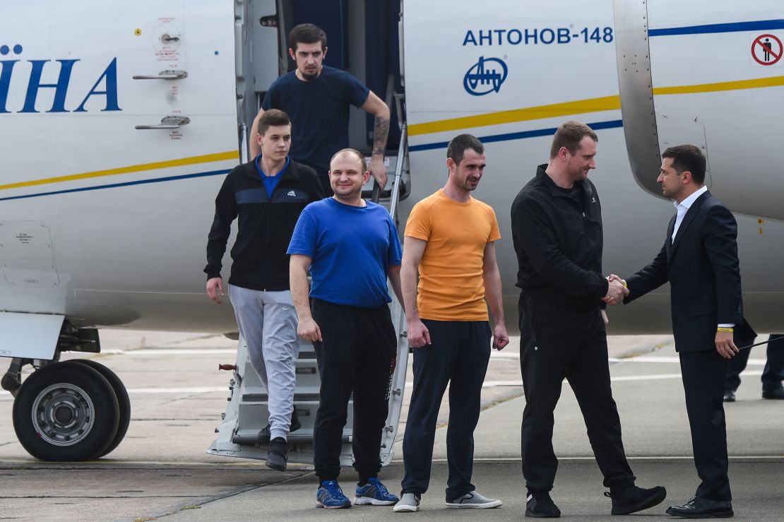 Ukraine's President Volodymyr Zelensky welcomes former prisoners as they disembark from the plane.