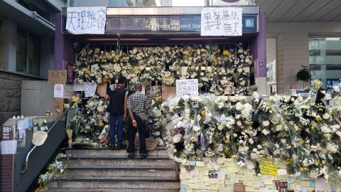 Floral tributes close off an entrance at Hong Kong's Prince Edward MTR station, after protesters accuse police of using excessive violence in the station.
