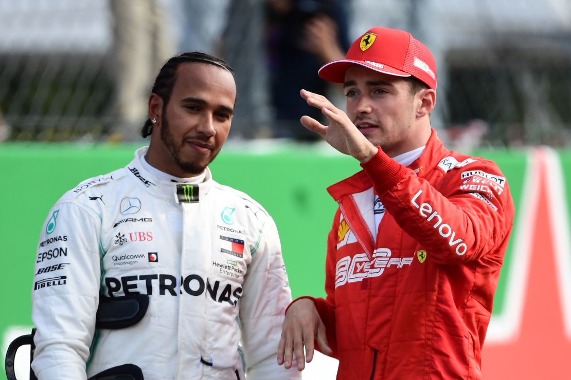 Charles Leclerc speaks with Lewis Hamilton during qualifying