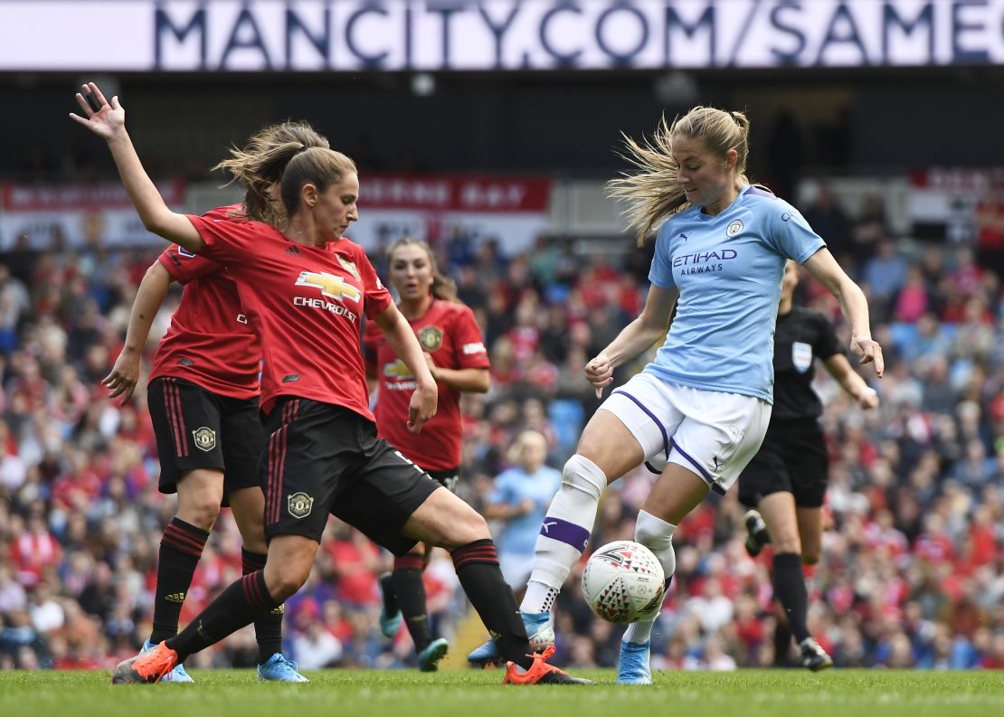 Abbie McManus tackles Janine Beckie during the Manchester derby.