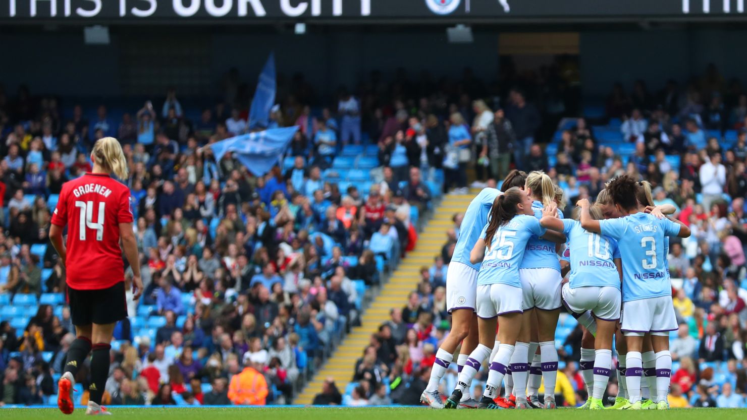 Manchester City players celebrate Caroline Weir's winning goal.