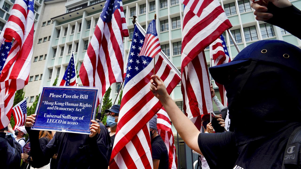 Protesters wave United States flags during a protest in Hong Kong on Sunday September 8.