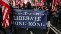 Protesters hold a banner and wave US national flags as they march from Chater Garden to the US consulate in Hong Kong on September 8, 2019, to call on the US to pressure Beijing to meet their demands and for Congress to pass a recently proposed bill that expresses support for the protest movement. - Pro-democracy activists planned to rally outside the US consulate in Hong Kong on September 8 as the they try to keep international pressure on Beijing following three months of huge, sometimes violent, protests. (Photo by Vivek Prakash / AFP)        (Photo credit should read VIVEK PRAKASH/AFP/Getty Images)