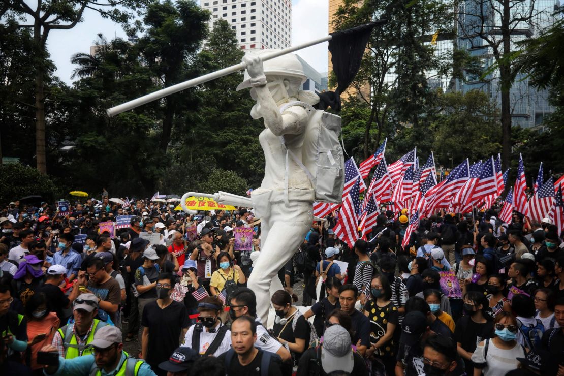 Protesters wave US national flags as they march from Chater Garden to the US Consulate in Hong Kong on September 8.