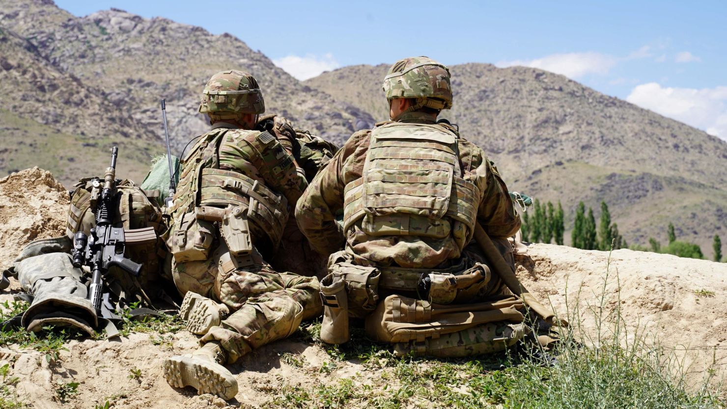 In this June 6, 2019, file photo, US soldiers look out over  a hillside at the Afghan National Army checkpoint in Nerkh district of Wardak province, Afghanistan.