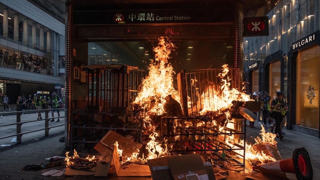 A barricade burns at an entrance to a train statio on September 8 in Hong Kong, China.