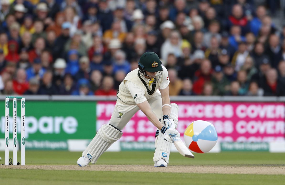 Australia's Steve Smith swats at a beach ball that entered the field during Day 1 of the fourth Ashes Test cricket match between England and Australia at Old Trafford in Manchester, England, on September 4. 