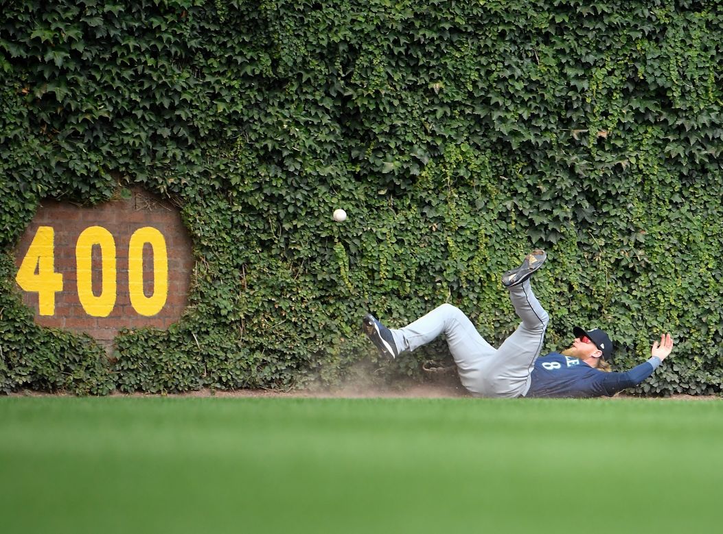 Seattle Mariners outfielder Jake Fraley falls on the warning track while attempting to make a catch in the third inning of a game against the Chicago Cubs at Wrigley Field on September 2.