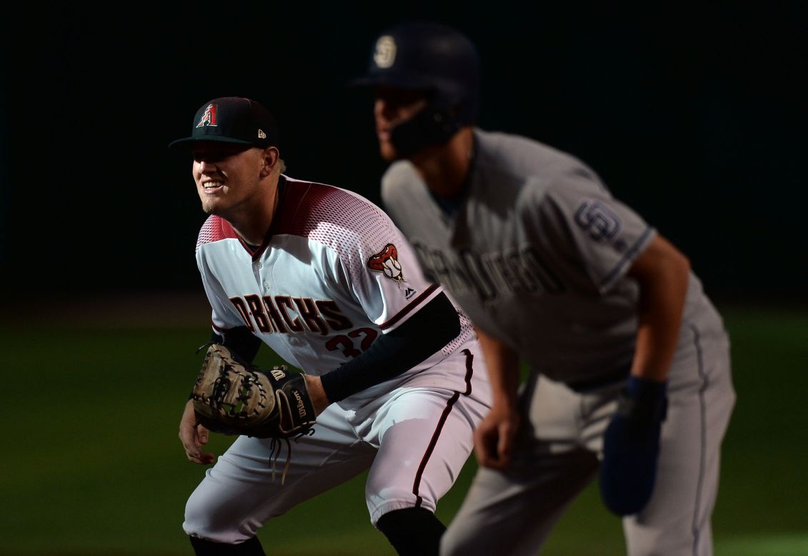 Arizona Diamondbacks first baseman Kevin Cron, left, covers first base as San Diego Padres center fielder Wil Myers leads off the bag during the ninth inning at Chase Field, on September 2.