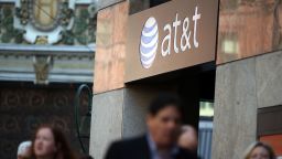 SAN FRANCISCO, CA - OCTOBER 23:  Pedestrians walk by an AT&T store on October 23, 2013 in San Francisco, California. AT&T is going to report third-quarter earnings after the closing bell.  (Photo by Justin Sullivan/Getty Images)