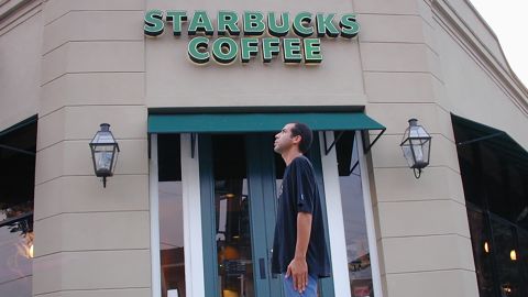 Winter stands in front of one of the more than 15,000 Starbucks he has visited.