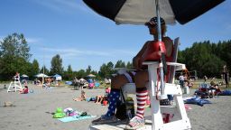 Lifeguard Luke Orot watches over swimmers at Jewel Lake on a hot July 4 in Anchorage.