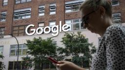 NEW YORK, NY - JUNE 3: A woman looks at her smartphone as she walks past Google Building 8510 at 85 10th Ave on June 3, 2019 in New York City. Shares of Google parent company Alphabet were down over six percent on Monday, following news reports that the U.S. Department of Justice is preparing to launch an anti-trust investigation aimed at Google. (Photo by Drew Angerer/Getty Images)