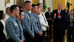 President Donald Trump applauds during a Medal of Valor and Heroic Commendations ceremony for six Dayton, Ohio police officers in the East Room of the White House, Monday, September 9, in Washington, for stopping a mass shooter in August, in Dayton. 