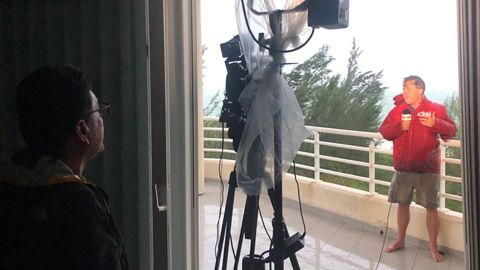 Jose Armijo shoots Patrick Oppmann's reporting from the balcony of an ocean-view apartment as Hurricane Dorian pounds Freeport.