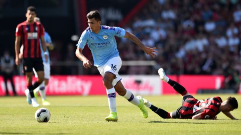 Manchester City's Spanish midfielder Rodri (C) tackles Bournemouth's Welsh midfielder Harry Wilson.