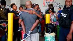 Mark Winder, center, of Tampa, Fla., embraces his niece, Gabriella Winder, 10, of Freeport, Grand Bahamas, as Gabriella and her family arrive to the Port of Palm Beach on the Grand Champion cruise ship in Riviera Beach, Fla., on Saturday, Sept. 7, 2019. The ship transported passengers leaving Freeport,  that were effected by the damaged caused by Hurricane Dorian. (AP Photo/Brynn Anderson)