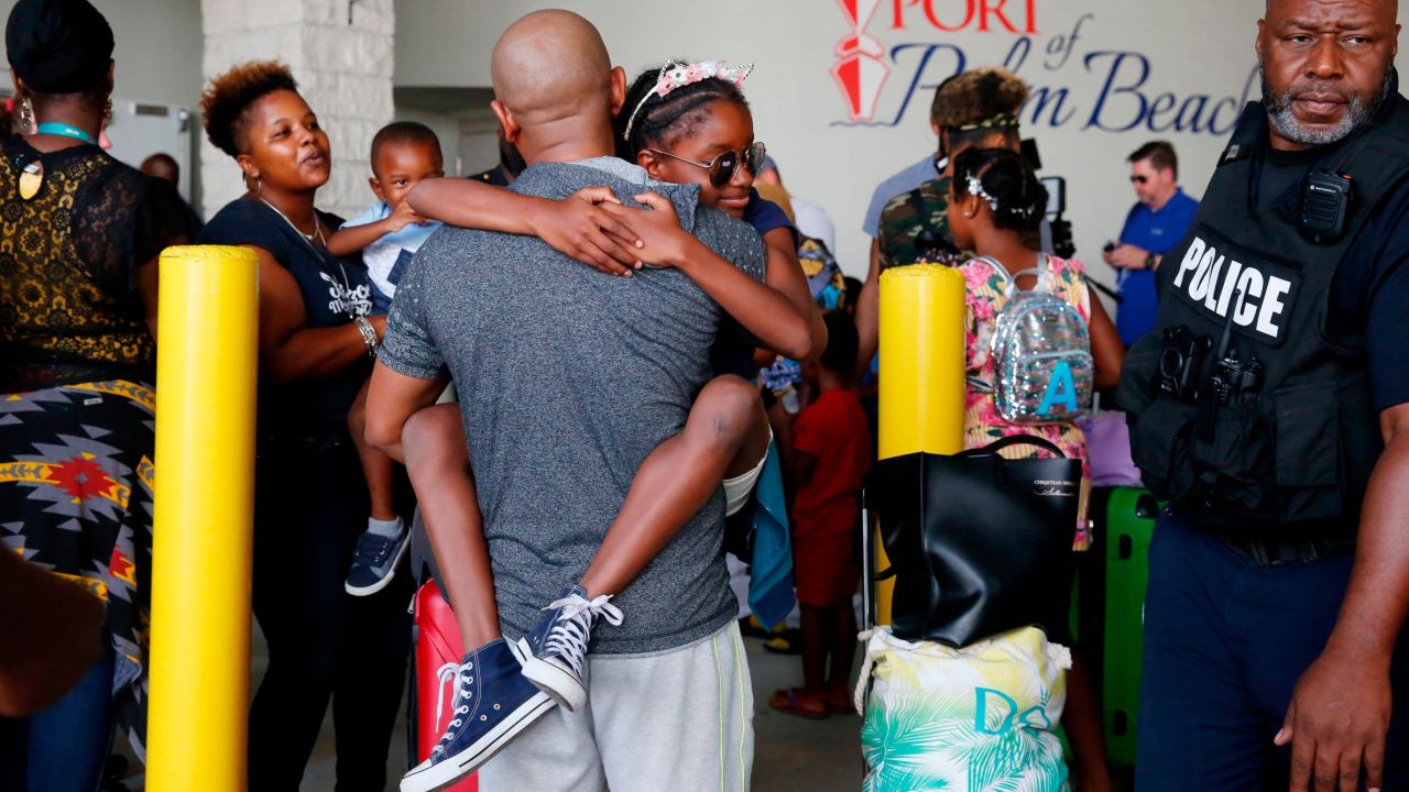 Mark Winder of Tampa, Florida, embraces his niece, Gabriella Winder, 10, as she and her family arrive in Riviera Beach, Florida, from the Bahamas on Saturday, September 7.