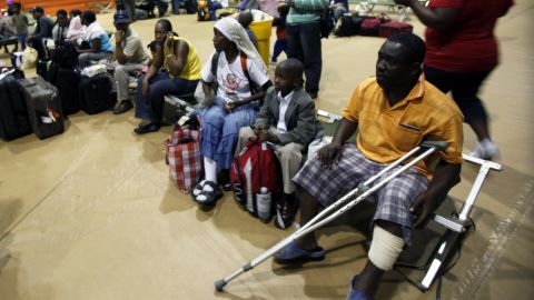 A group of evacuees from Haiti wait for transportation as they clear customs at Homestead Air Reserve Base, Florida, in January 2010.