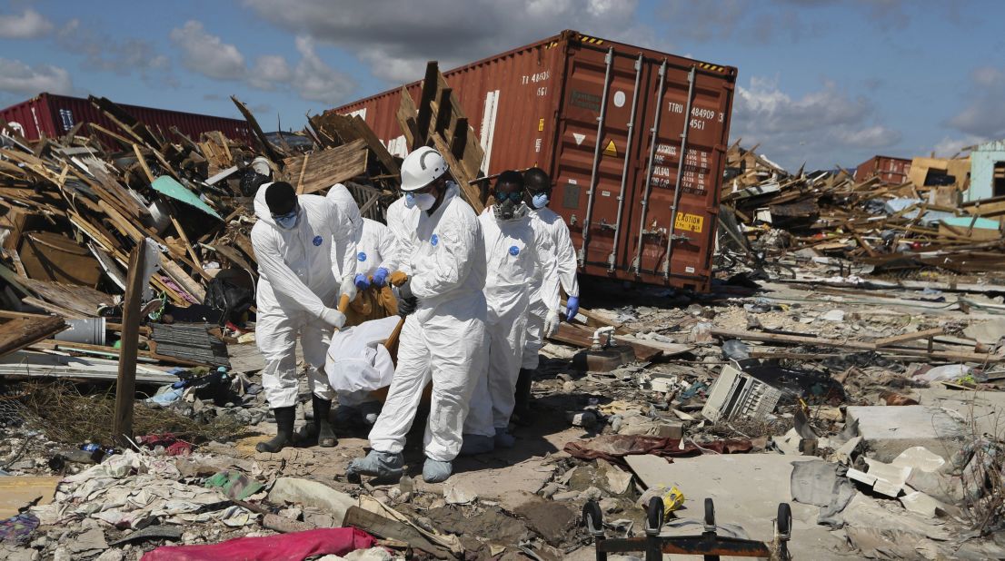 A body is carried out of the Mudd neighborhood in Marsh Harbour, Bahamas, on Monday, September 9.