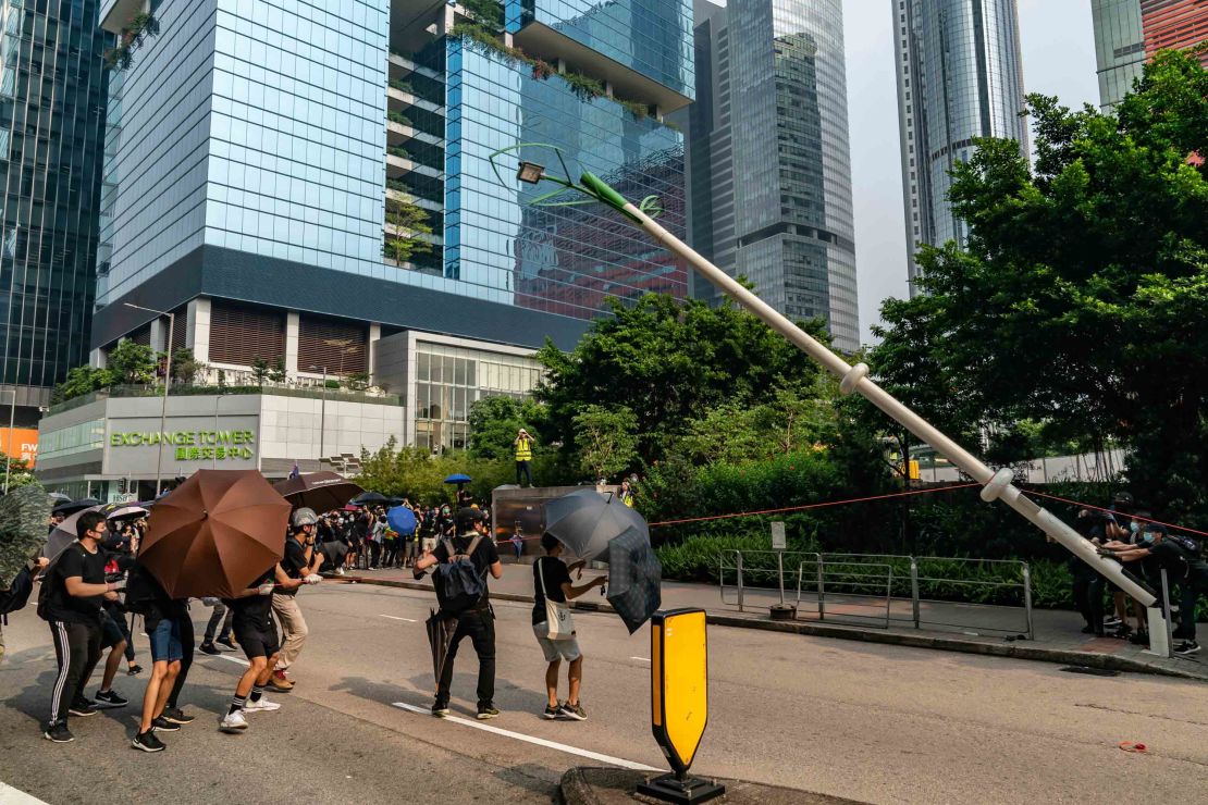Protesters attempt to pull down a "smart" lamp post during an anti-government rally in Hong Kong on August 24.