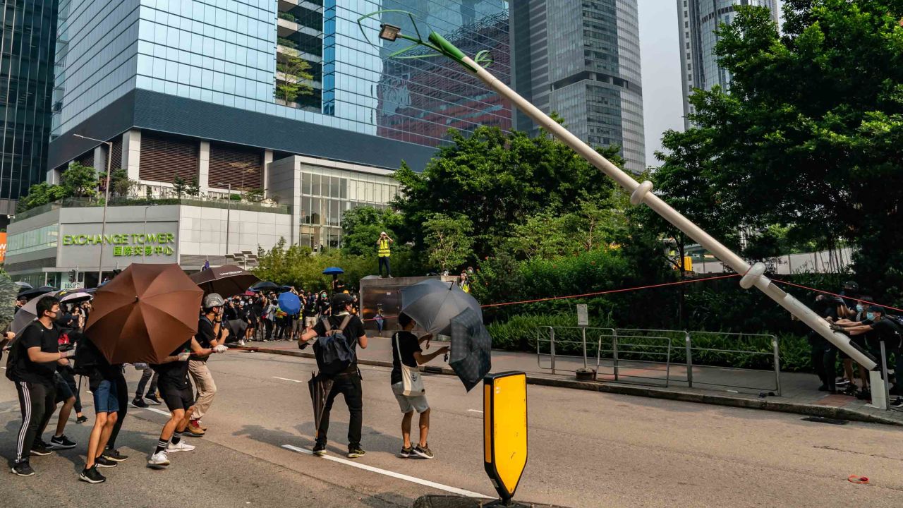 Protesters attempt to pull down a "smart" lamp post during an anti-government rally in Hong Kong on August 24.