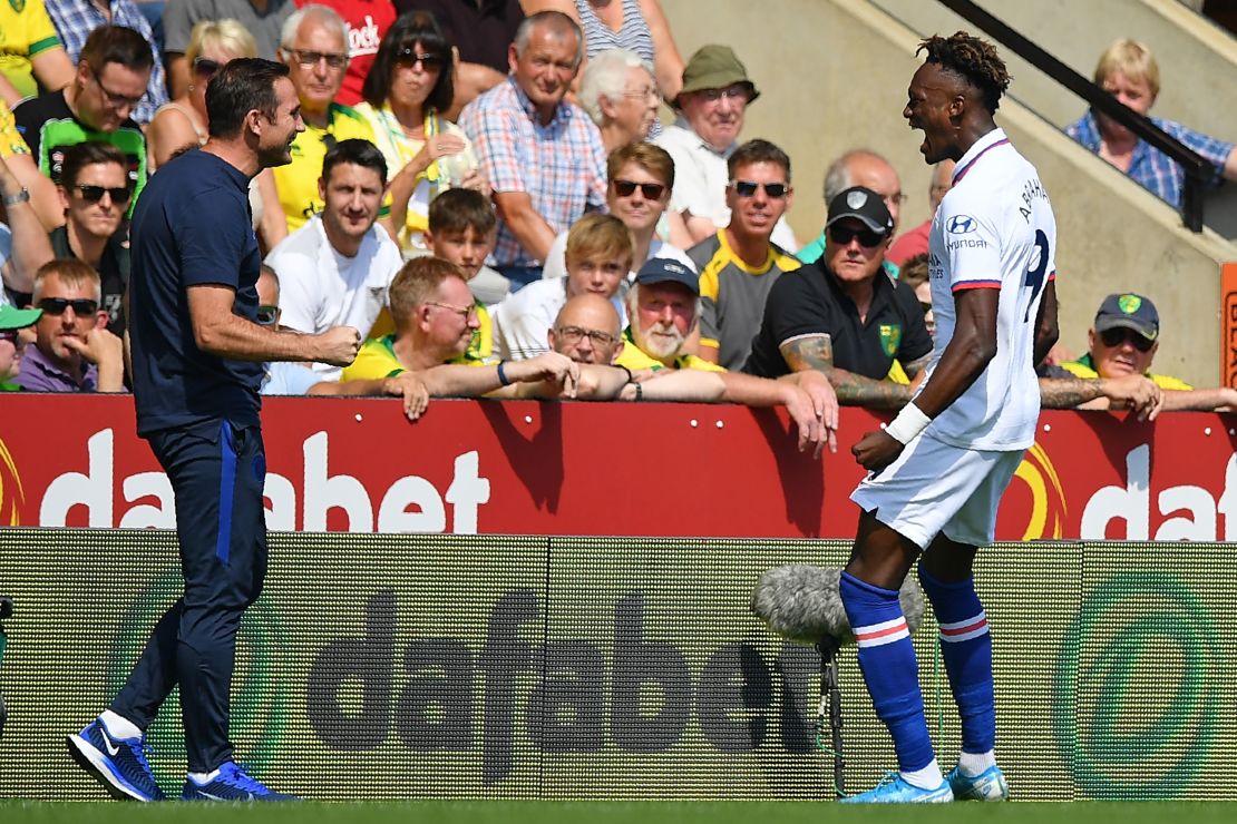 Chelsea striker Tammy Abraham  runs over to celebrate with Chelsea's manager Frank Lampard after scoring.