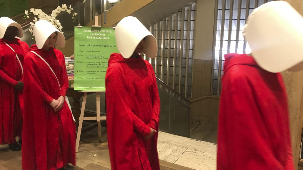 Actors dressed as characters from the new Margaret Atwood novel, The Testaments at the Piccadilly branch of Waterstones as they promote an audience with the author ahead of the midnight release of the new book.