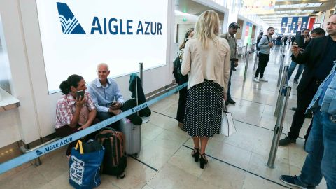 Passengers wait in front of the French airline Aigle Azur reception desk, without any employees, at Orly airport in Paris last week
 (Photo by Michel Stoupak/NurPhoto via Getty Images)