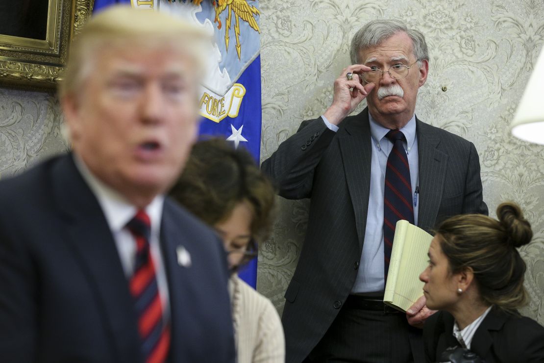 US President Donald Trump speaks as National security advisor John Bolton listens during a meeting in May 2018 in Washington DC. Democrats want to hear from Bolton in their impeachment inquiry but he has thus far refused to show.