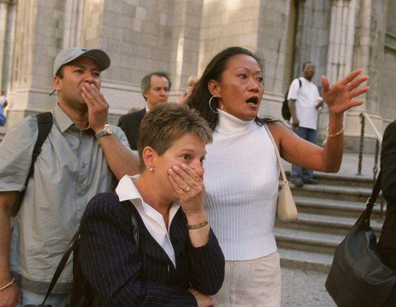 People in front of St. Patrick's Cathedral react with horror as they look down Fifth Avenue toward the World Trade Center site.