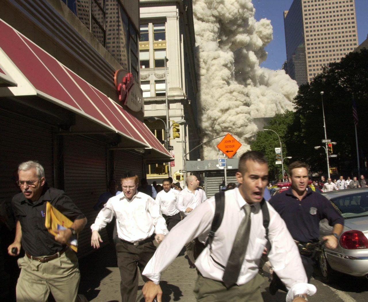 People run as the building collapses.