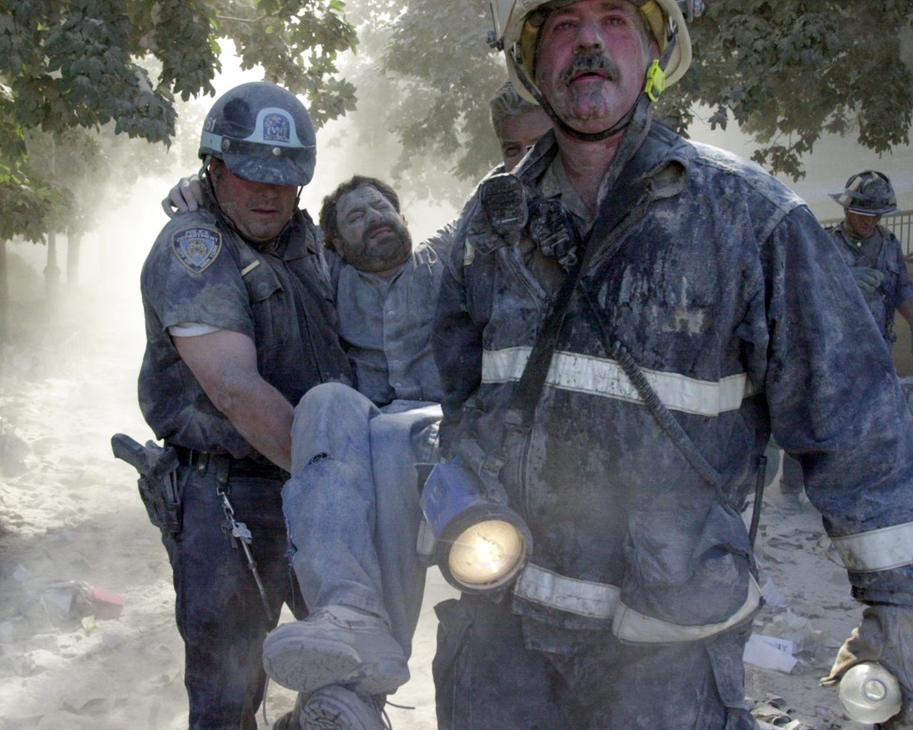 New York Daily News photographer David Handschuh is carried after his leg was shattered by falling debris.