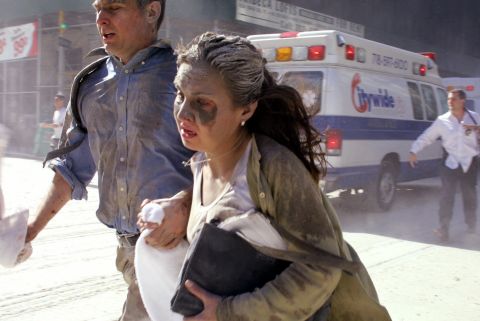 Dust-covered survivors run through New York's streets after the towers collapsed.