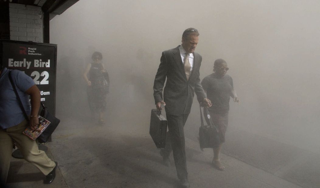 People in New York navigate through a dust cloud.