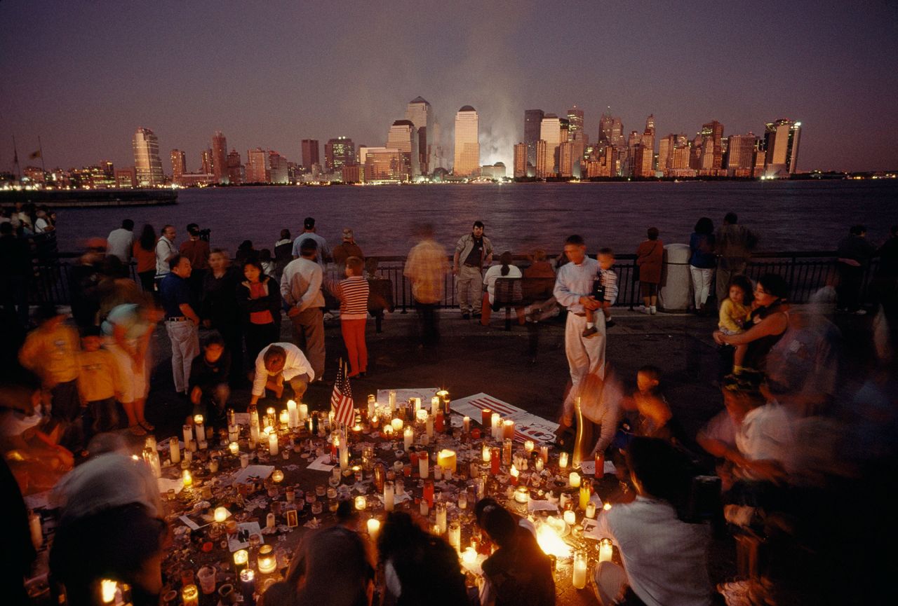 People in New York gather for a candlelight vigil a day after the attacks.