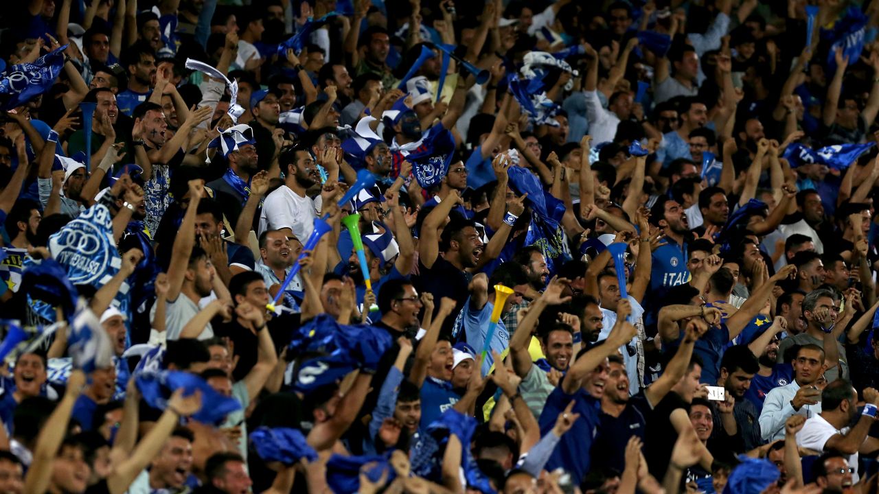 Iranian fans cheer for their team during the AFC Champions League football match Al-Sadd vs Esteghlal FC.