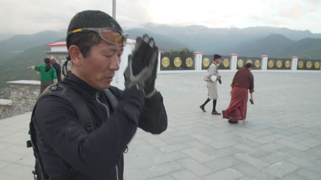 Prime Minister Dr. Lotay Tshering prays outside of Buddha Dordenma.