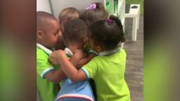 preschoolers hug classmate