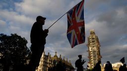 TOPSHOT - An anti-Brexit protester with a composite Union and EU flag is seen on Parliament Square outside the Houses of Parliament in central London on September 4, 2019. - British lawmakers inflicted a fresh defeat on Prime Minister Boris Johnson's Brexit strategy on Tuesday, approving in principle a law that could stop him taking Britain out of the European Union without a deal next month. (Photo by Tolga AKMEN / AFP)        (Photo credit should read TOLGA AKMEN/AFP/Getty Images)