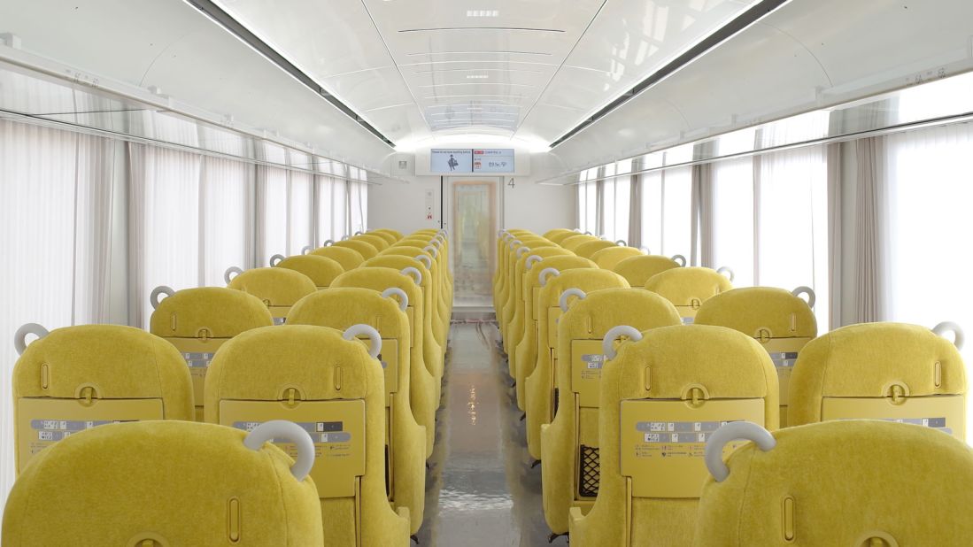 <strong>Cozy commute:</strong> The interior of the train is decked out with comfortable yellow chairs with an adjustable headrest and armrest table.