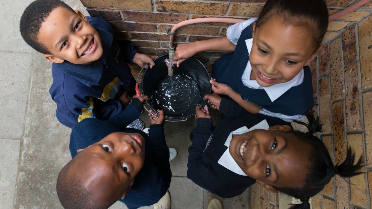 Schoolchildren at AF Louw Primary collect water during the Count Dropula project.