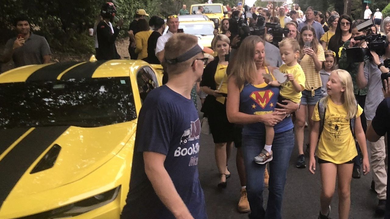 Whitaker surrounded by yellow cars on the way to school.