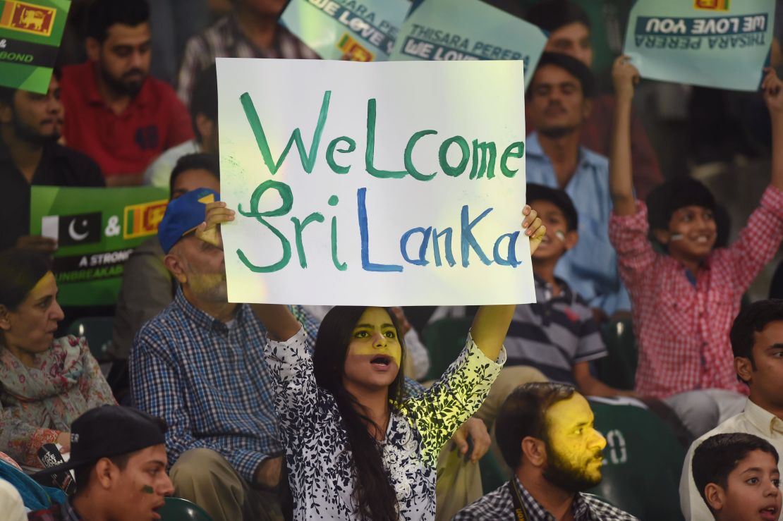 Pakistani spectator holds a placard while cheering during the T20 cricket match between Pakistan and Sri Lanka at the Gaddafi Cricket Stadium in Lahore on October 29, 2017.
