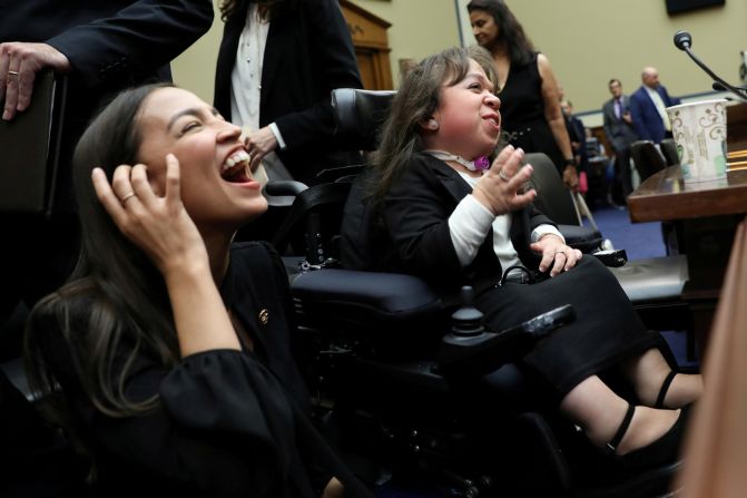 US Rep. Alexandria Ocasio-Cortez laughs with Maria Isabel Bueso after Bueso testified at a House subcommittee hearing on Wednesday, September 11. Bueso, who has a rare genetic disease, was 7 years old when she left Guatemala and came to the United States to participate in a clinical trial. She had been granted relief from deportation due to her medical condition. But now she and some others <a href="https://www.cnn.com/2019/09/11/politics/uscis-deferred-action-hearing/index.html" target="_blank">have been left in limbo</a> following a policy change revoking that relief.