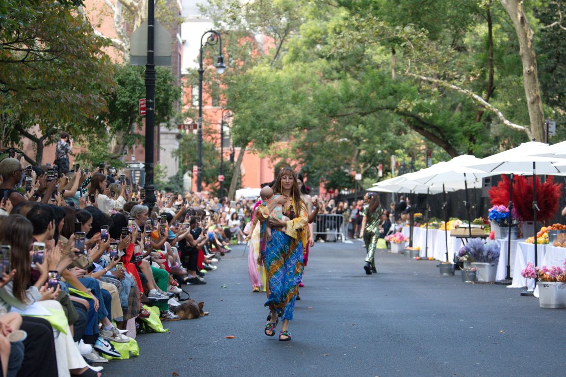 A model walks for the Collina Strada show. A farmer's market was staged as part of the runway. 