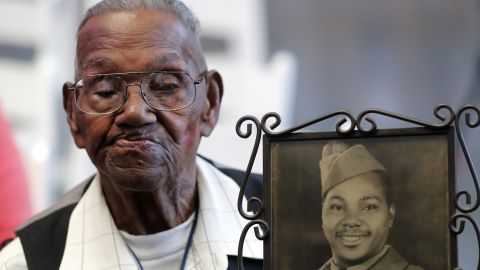 World War II veteran Lawrence Brooks holds a photo of him taken in 1943.