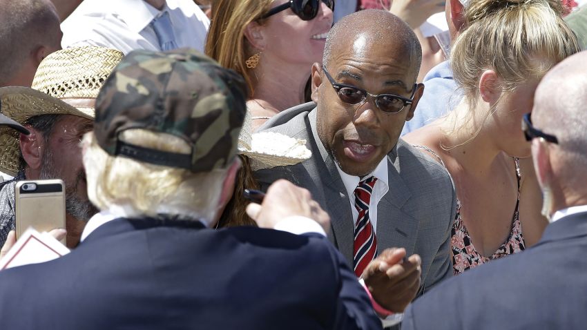 In this photo taken Friday, June 3, 2016, Republican presidential candidate Donald Trump, left, talks to Gregory Cheadle as he leaves a campaign rally at the Redding Municipal Airport, in Redding, Calif. Cheadle, whom Trump singled out while calling him "my African-American," said Monday that he is now the target of harsh criticism, including comments he feels are more racist than the remark by the presumptive Republican presidential nominee. Cheadle also said Monday that he was not there to back Trump and that he is considering other possibilities as well, including Democratic candidate Sen. Bernie Sanders. (AP Photo/Rich Pedroncelli)