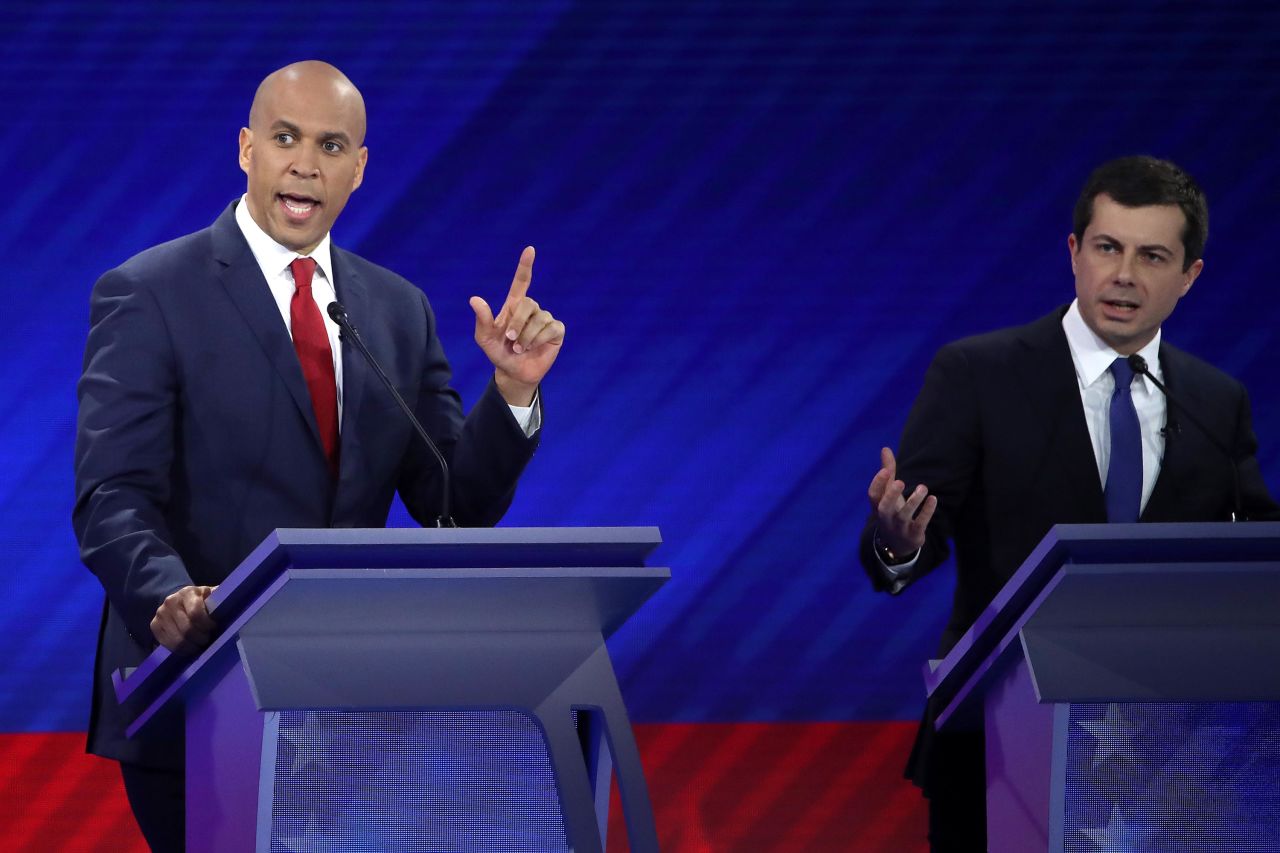 Booker and Buttigieg interact during the debate.