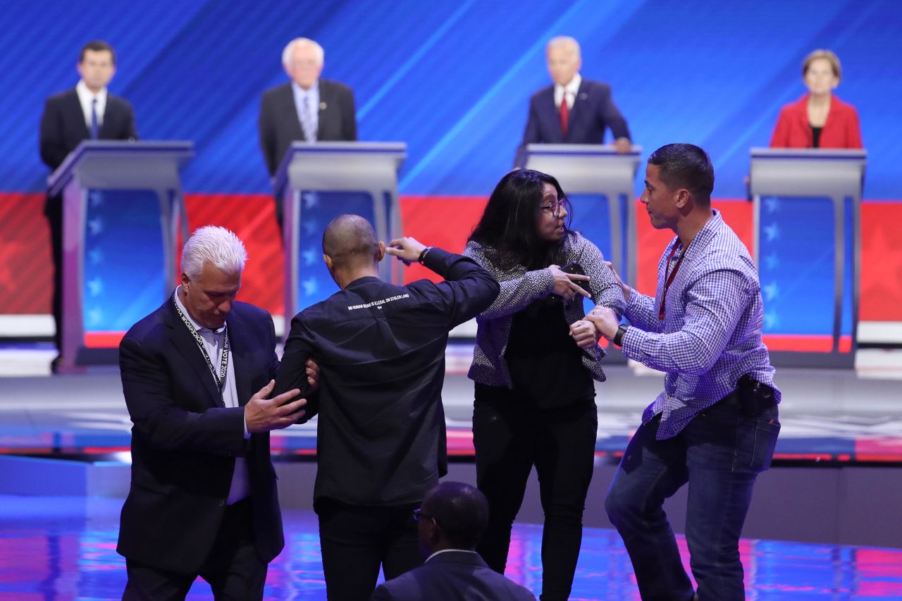 Protesters are escorted out by security after <a href="https://www.cnn.com/politics/live-news/democratic-debate-september-2019/h_71c1a6fd3eabdc569e076030b4bfb590" target="_blank">interrupting Biden's closing statement.</a> Watching on television, it was unclear what they were yelling.
